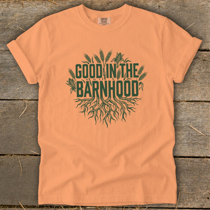 Peach t-shirt with green "Good in the Barnhood" graphic featuring roots and wheat.