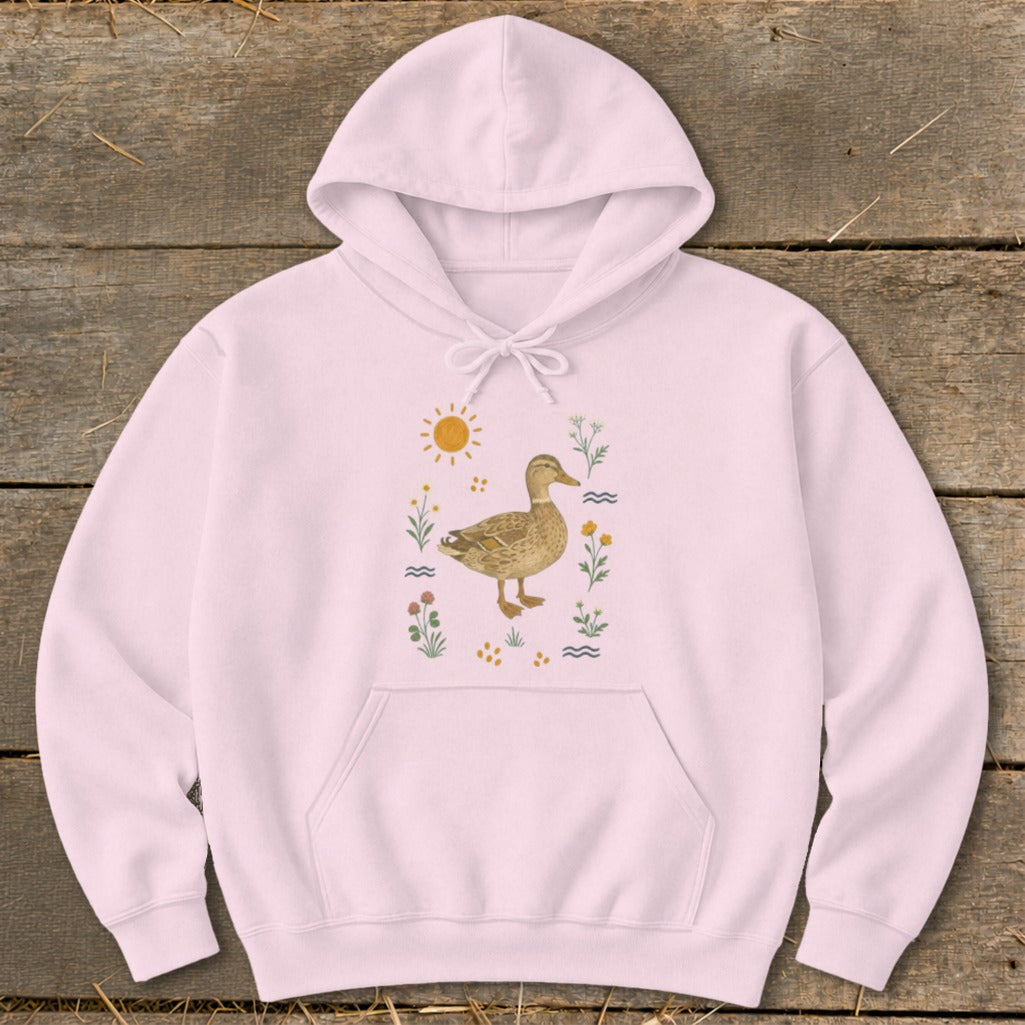 Pink hoodie with a duck illustration surrounded by flowers and a sun.