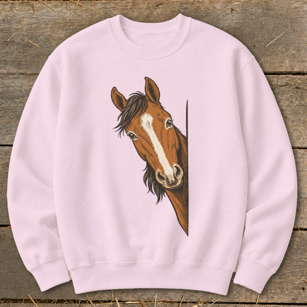Pink sweatshirt with a brown horse peeking from the side.