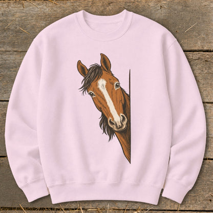 Pink sweatshirt with a brown horse peeking from the side.