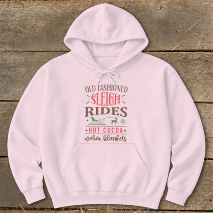Pink hoodie with "Old Fashioned Sleigh Rides Hot Cocoa Warm Blankets" graphic.