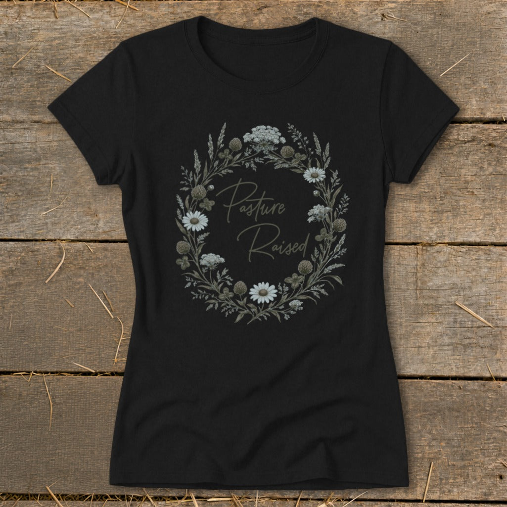 Black t-shirt with floral wreath graphic and "Pasture Raised" text.