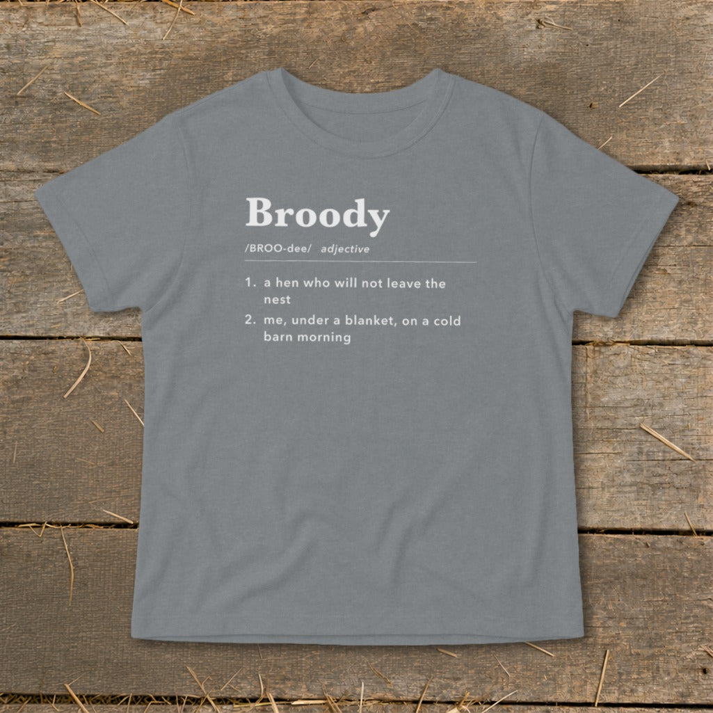 Gray t-shirt with "Broody" definition: "a hen who will not leave the nest; me, under a blanket, on a cold barn morning."