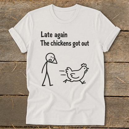White t-shirt with stick figure and running chicken, text "Late again The chickens got out".