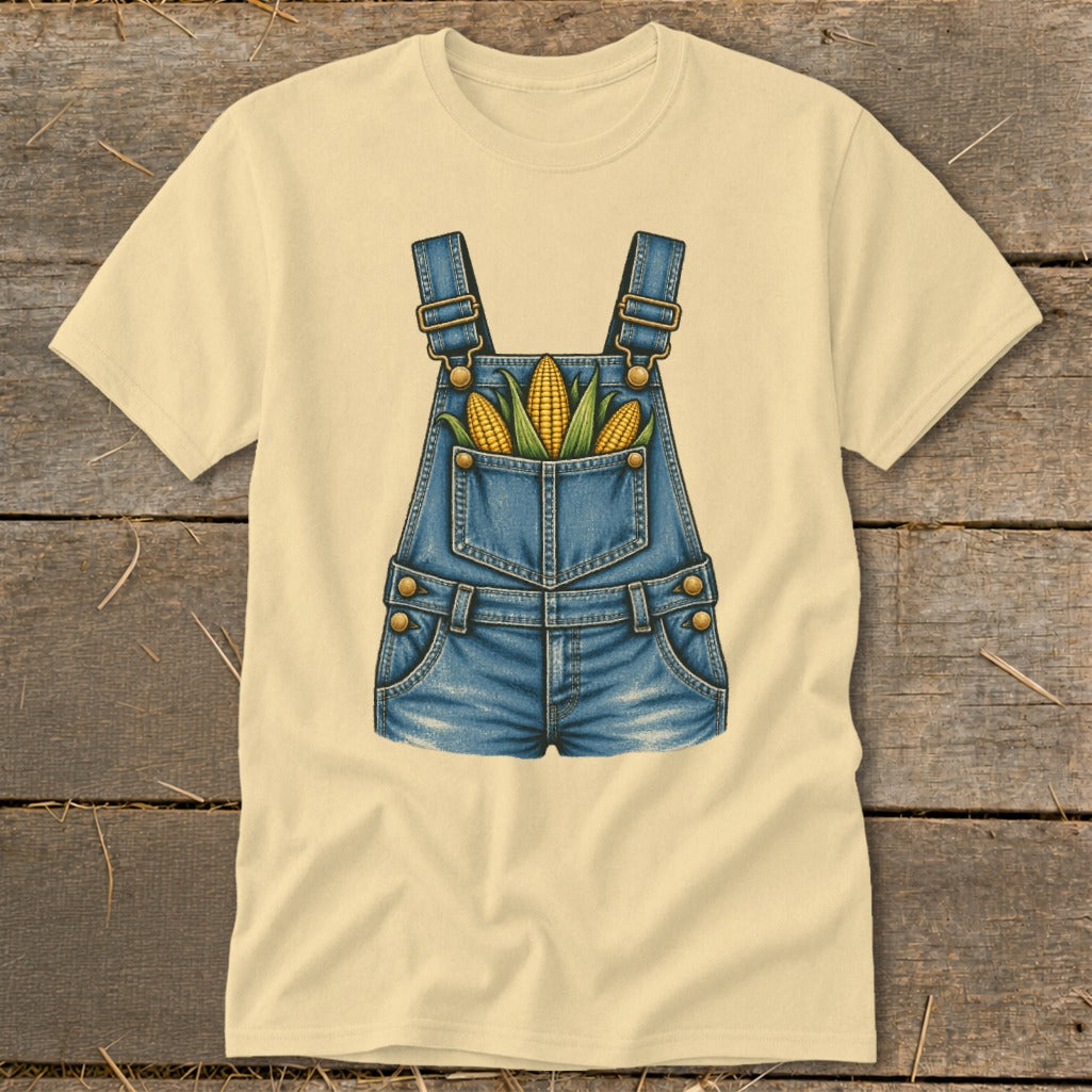 Cream t-shirt with a denim overall graphic featuring three ears of corn in the pocket.