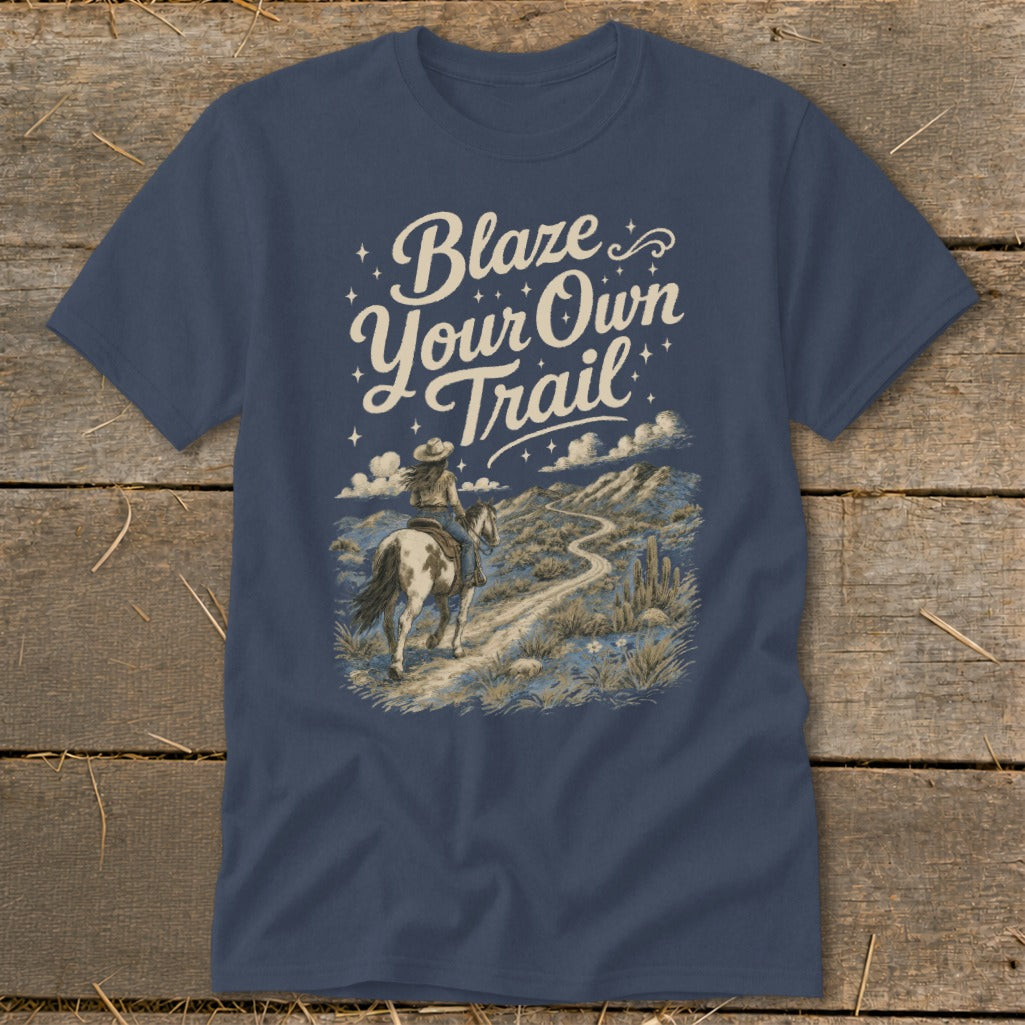 T-shirt with "Blaze Your Own Trail" text and rider on horse in desert landscape.