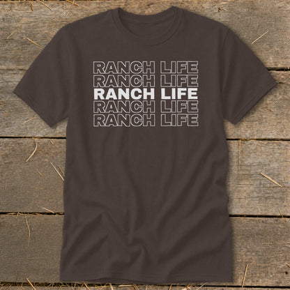 Dark brown t-shirt featuring stacked white text that reads "RANCH LIFE" on a wooden background.