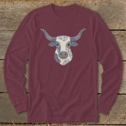 Maroon long-sleeve shirt featuring a patchwork bull's head graphic with blue gingham and floral patterns.
