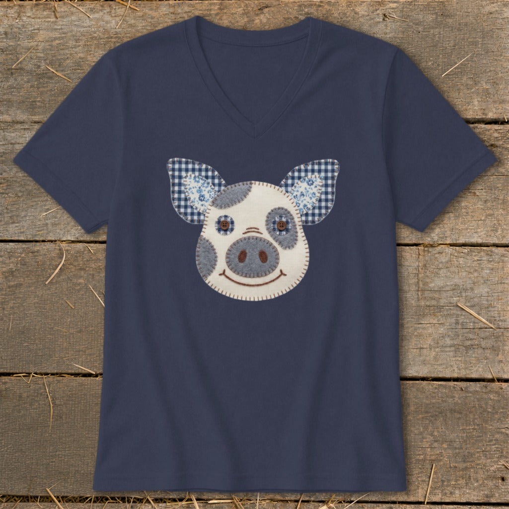 Navy v-neck t-shirt with a felt pig face applique and checkered ears.