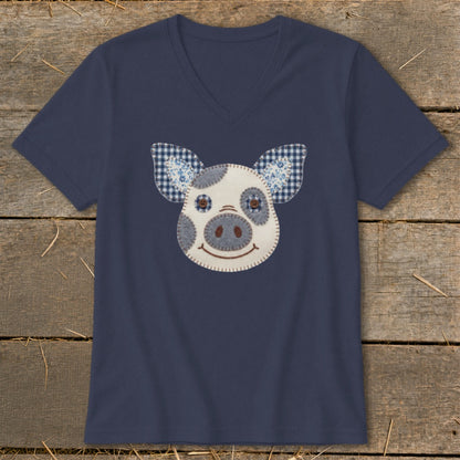 Navy v-neck t-shirt with a felt pig face applique and checkered ears.