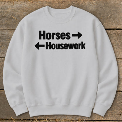 Light gray crewneck sweatshirt printed with the black text Horses right arrow and left arrow Housework.