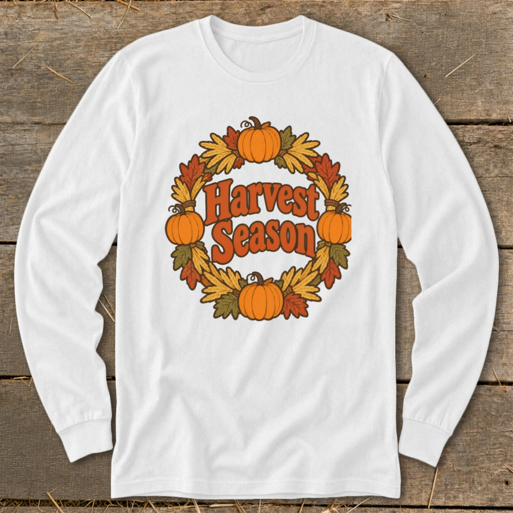 White long-sleeve shirt with a circular harvest graphic featuring pumpkins and leaves.