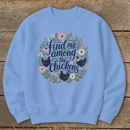 Light blue sweatshirt with a floral wreath graphic containing chickens and the text "find me among the chickens."