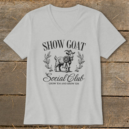 "Show Goat Social Club" text with goat graphic and ribbon on a light grey v-neck shirt.