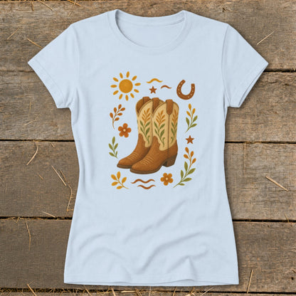 Light blue t-shirt with cowboy boots, sun, horseshoe, and floral graphic.