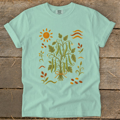 Light mint green t-shirt with embroidered sun, pea plant, and botanical elements.