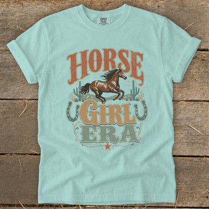 Light blue t-shirt with vintage "Horse Girl Era" text and horse graphic.