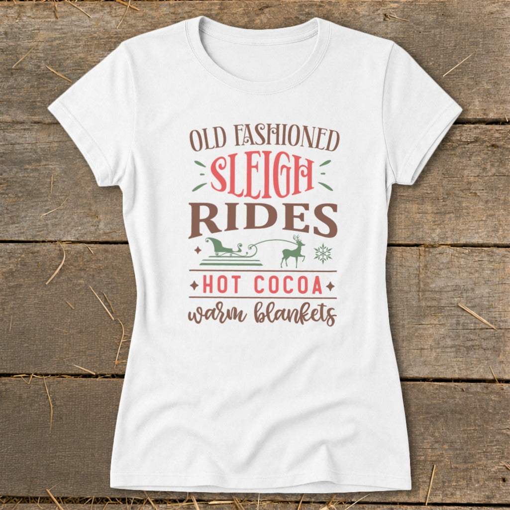 White t-shirt with "Old Fashioned Sleigh Rides Hot Cocoa Warm Blankets" text and graphics.