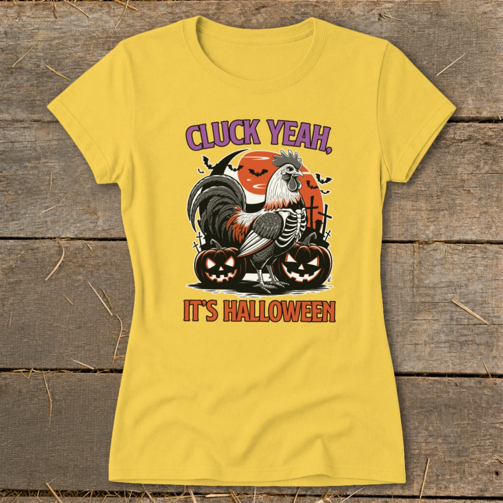Yellow t-shirt with rooster skeleton, pumpkins, and text "CLUCK YEAH, IT'S HALLOWEEN".