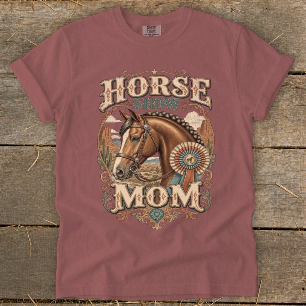 Horse Show Mom graphic with horse, ribbon, and desert landscape on a rose t-shirt.