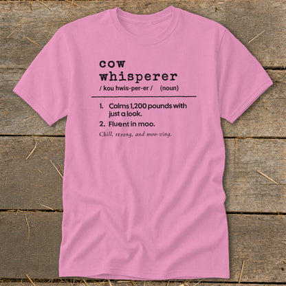 Pink t-shirt with black text defining "cow whisperer" and its attributes.