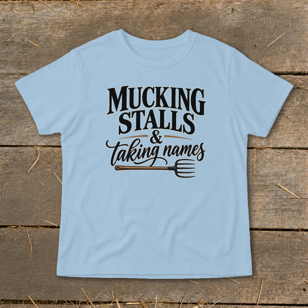 Light blue t-shirt with "Mucking Stalls & Taking Names" text and pitchfork graphic.
