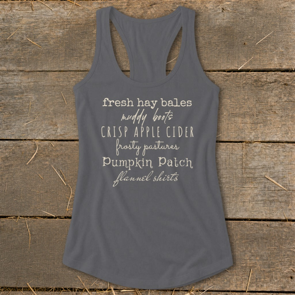 Gray tank top with text "fresh hay bales, muddy boots, crisp apple cider, frosty pastures, pumpkin patch, flannel shirts".