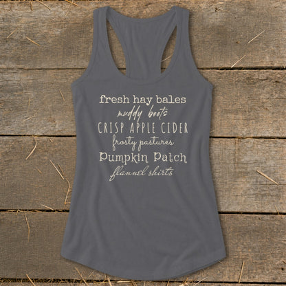Gray tank top with text "fresh hay bales, muddy boots, crisp apple cider, frosty pastures, pumpkin patch, flannel shirts".