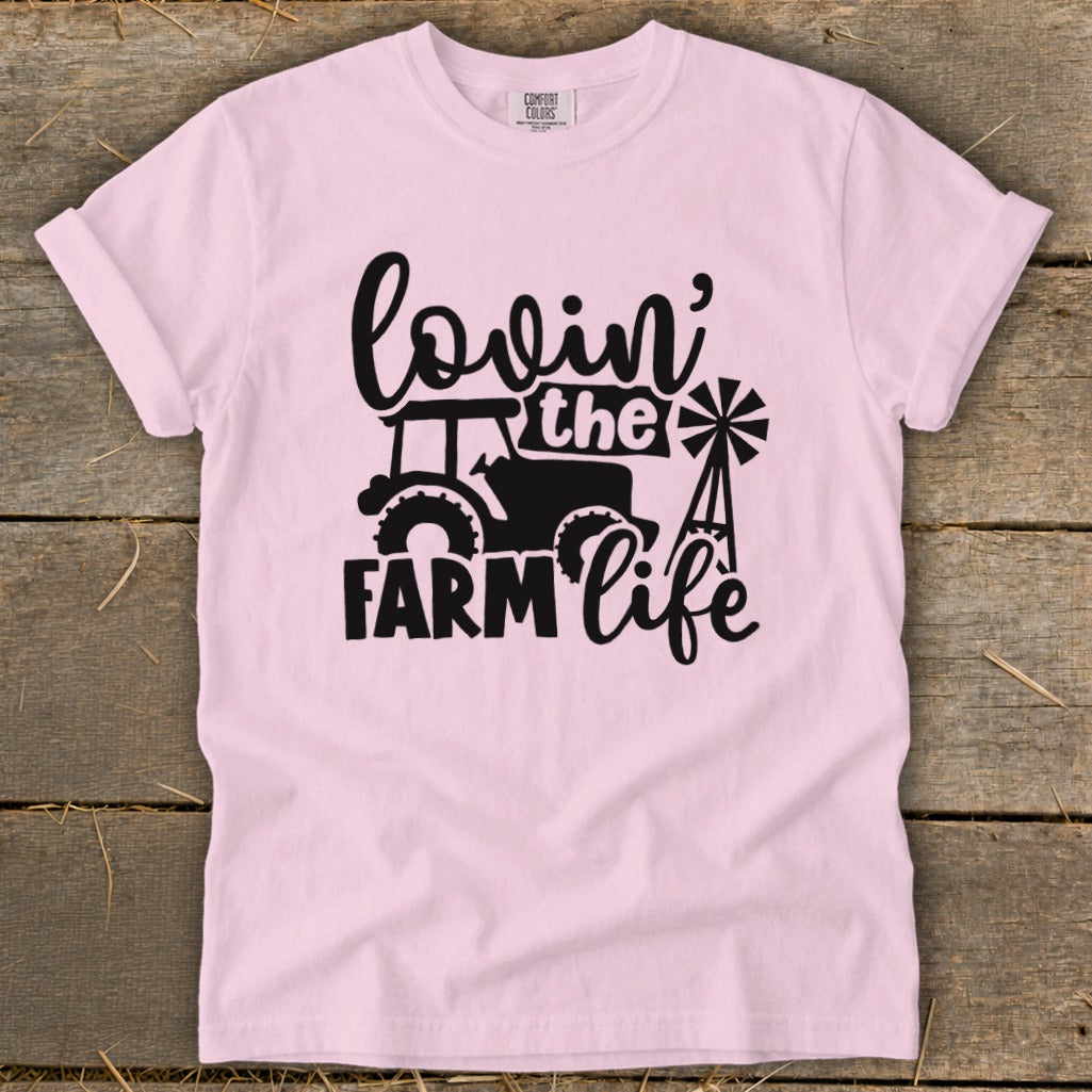 Pink t-shirt with black graphic: "Lovin' the Farm Life" with tractor and windmill.