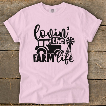 Pink t-shirt with black graphic: "Lovin' the Farm Life" with tractor and windmill.