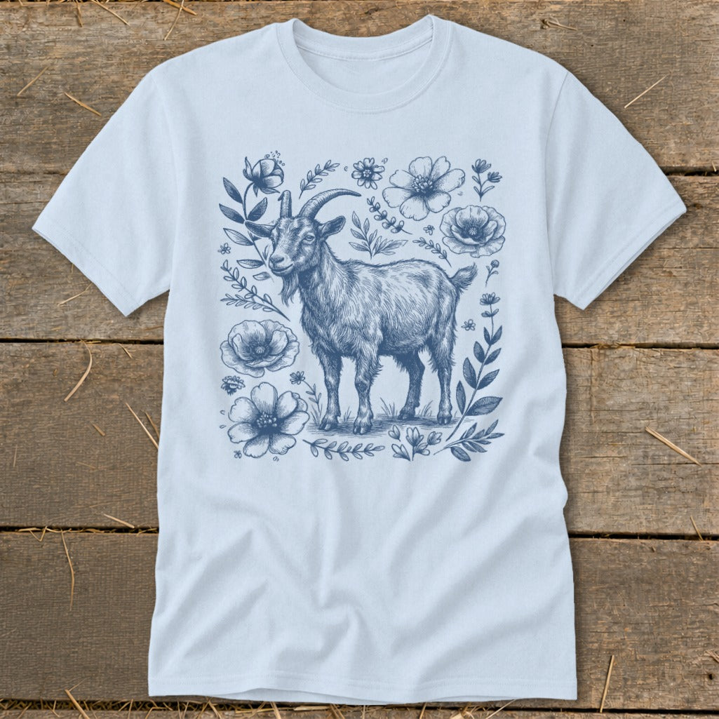 Light blue t-shirt with a blue line drawing of a goat surrounded by floral elements.