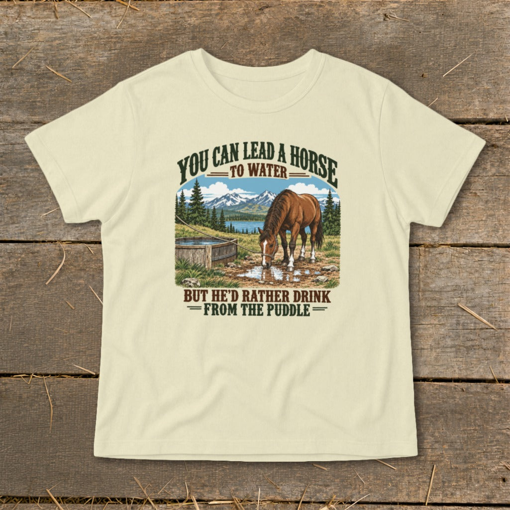 Light-colored t-shirt featuring a horse drinking from a puddle with text referencing horse water behavior.