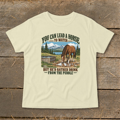 Light-colored t-shirt featuring a horse drinking from a puddle with text referencing horse water behavior.