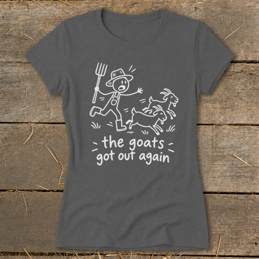 Dark gray t-shirt with a white line drawing of a farmer chasing goats and text reading "the goats got out again".