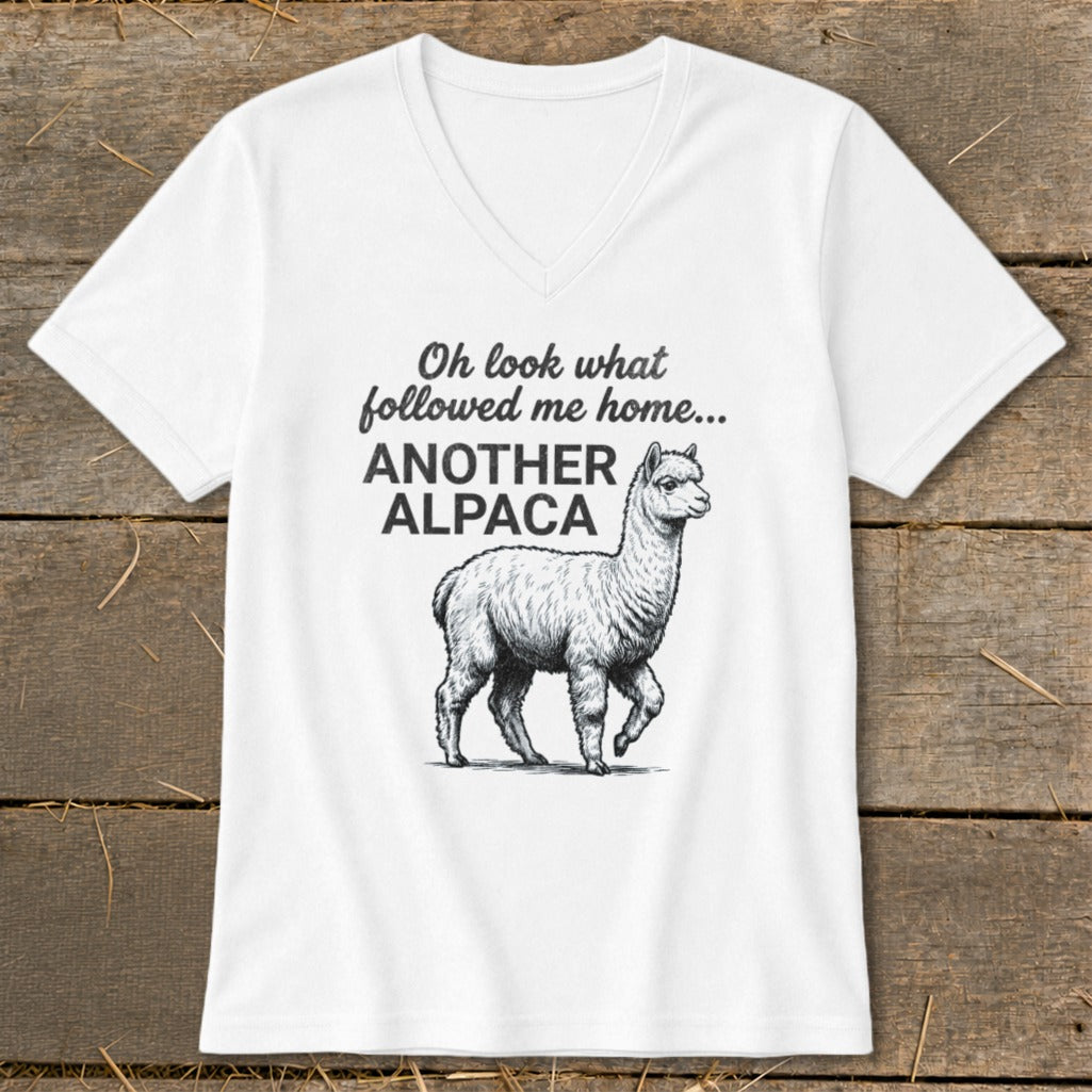 White v-neck t-shirt with illustration of an alpaca and text "Oh look what followed me home... ANOTHER ALPACA".