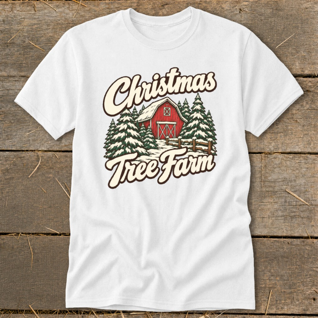 White t-shirt with "Christmas Tree Farm" graphic featuring a red barn and pine trees.