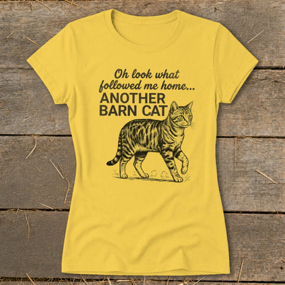 Yellow t-shirt with text "Oh look what followed me home... ANOTHER BARN CAT" and a tabby cat illustration.