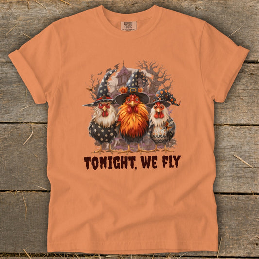 Three chickens in witch hats and Halloween-themed outfits, with text "TONIGHT, WE FLY".