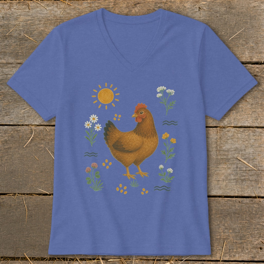 Brown chicken illustration surrounded by flowers, sun, and wavy lines on a blue v-neck shirt.