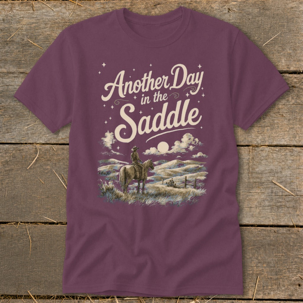 T-shirt with "Another Day in the Saddle" text and cowboy on horse graphic.