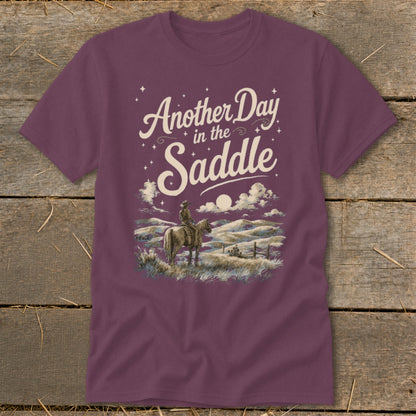 T-shirt with "Another Day in the Saddle" text and cowboy on horse graphic.