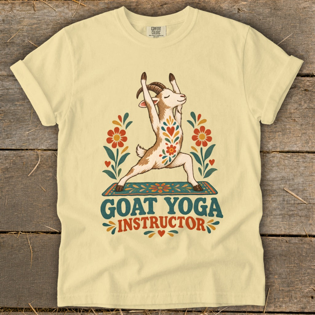 Light yellow t-shirt with a goat in a yoga pose, surrounded by flowers, text reads "GOAT YOGA INSTRUCTOR".