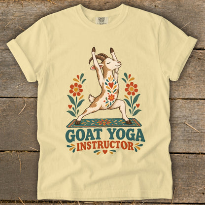 Light yellow t-shirt with a goat in a yoga pose, surrounded by flowers, text reads "GOAT YOGA INSTRUCTOR".