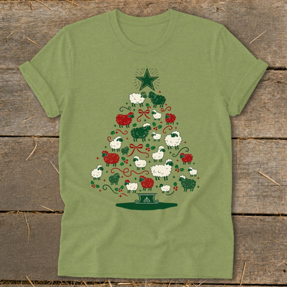 Green t-shirt with a Christmas tree made of sheep, holly, and bows.