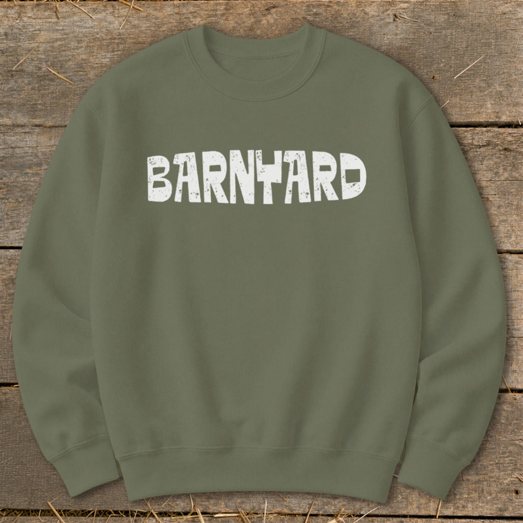An olive green crewneck sweatshirt with distressed white text reading BARNYARD centered on the chest.