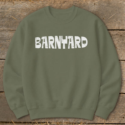 An olive green crewneck sweatshirt with distressed white text reading BARNYARD centered on the chest.