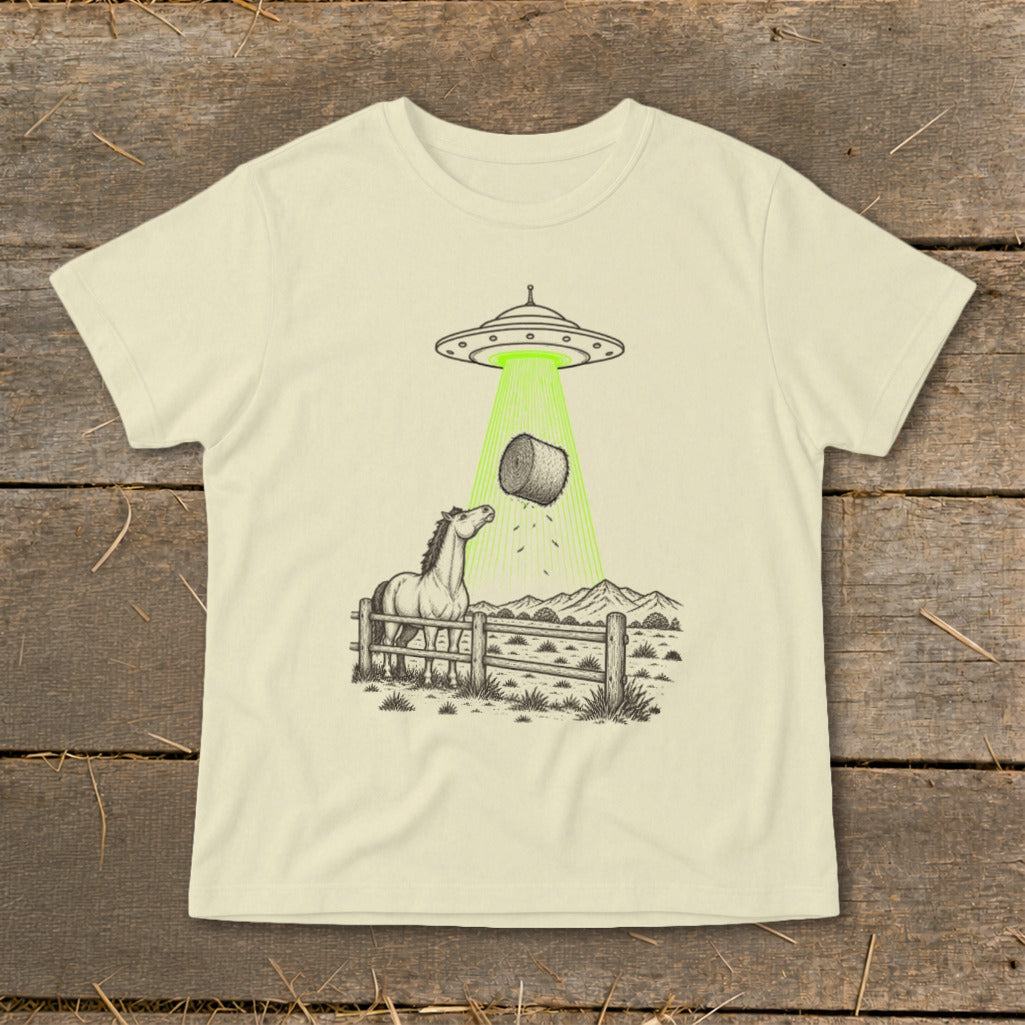 UFO abducting a hay bale with a horse looking up from a fenced pasture.