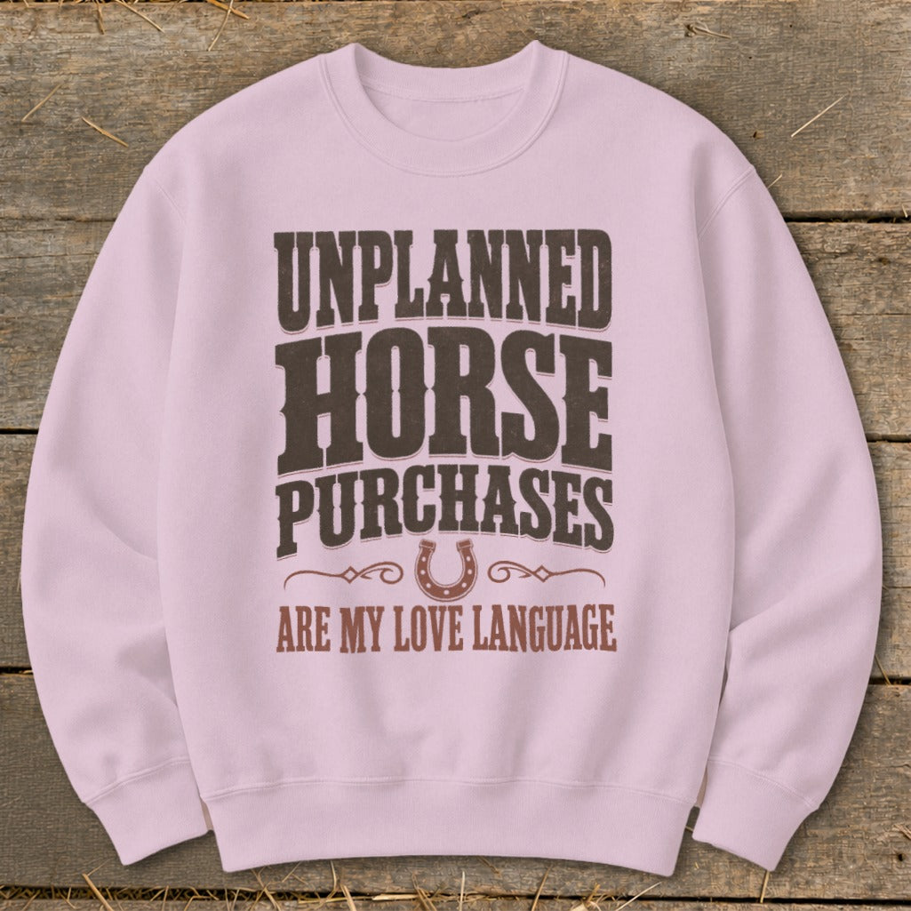 Pink sweatshirt with "Unplanned Horse Purchases Are My Love Language" text.