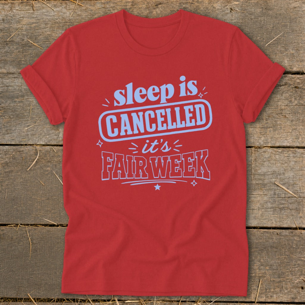Red t-shirt with blue text reading "sleep is CANCELLED it's FAIR WEEK".