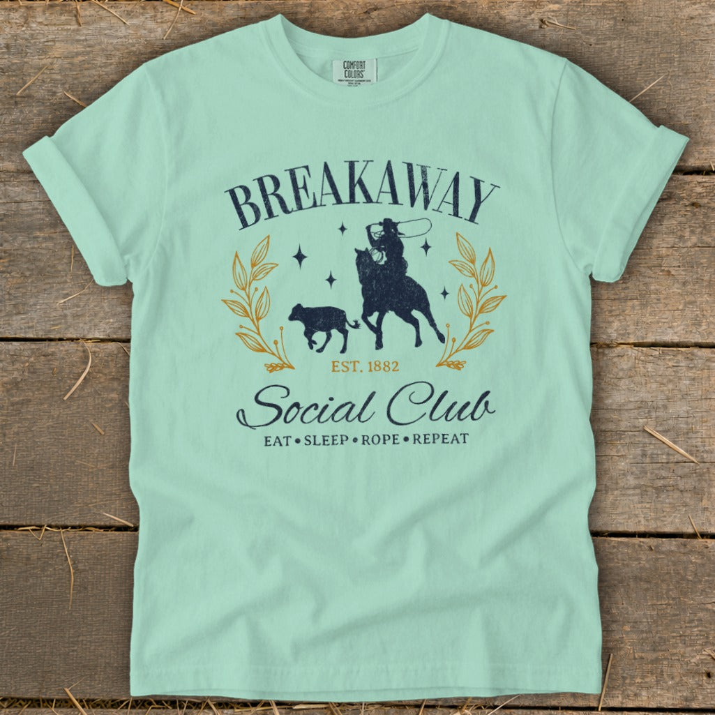 Mint t-shirt with "Breakaway Social Club" graphic featuring a cowboy, calf, and wreath.